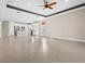 Open concept living room with tile floors and view of kitchen area at 17448 Silverspur Dr, Punta Gorda, FL 33982