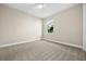 Simple bedroom with window, ceiling fan, and carpet at 17448 Silverspur Dr, Punta Gorda, FL 33982