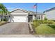 Single-story home with gray exterior, white garage door, and landscaped yard at 17448 Silverspur Dr, Punta Gorda, FL 33982