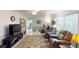 Living room with comfortable seating, exercise equipment and fireplace at 2376 Auburn Blvd, Port Charlotte, FL 33948