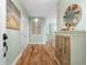 Bright entryway with hardwood floors, decorative wall niche, and built-in shelving at 268 Lewis Cir # 132, Punta Gorda, FL 33950
