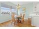 Bright dining area with a round table, four chairs, and a view at 268 Lewis Cir # 132, Punta Gorda, FL 33950
