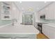 Bright eat-in kitchen with white cabinets and stainless steel appliances at 268 Lewis Cir # 132, Punta Gorda, FL 33950
