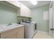 Laundry room with washer, dryer, cabinets, and a utility sink at 268 Lewis Cir # 132, Punta Gorda, FL 33950