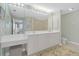 Double vanity bathroom with updated fixtures and a large mirror at 268 Lewis Cir # 132, Punta Gorda, FL 33950