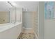 Spa-like bathroom with double vanity and glass block shower at 268 Lewis Cir # 132, Punta Gorda, FL 33950