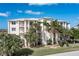 Three story building with palm trees and landscaping at 268 Lewis Cir # 132, Punta Gorda, FL 33950