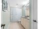 Bathroom with a shower/tub combo, light cabinets, and a coastal-themed shower curtain at 268 Lewis Cir # 132, Punta Gorda, FL 33950