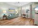 Comfortable living room featuring hardwood floors, a sofa, and a home office area at 268 Lewis Cir # 132, Punta Gorda, FL 33950