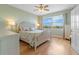 Bright bedroom with large windows, hardwood floors, and a ceiling fan at 268 Lewis Cir # 132, Punta Gorda, FL 33950