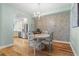 Charming dining area with hardwood floors, a round table and chairs, and kitchen access at 268 Lewis Cir # 132, Punta Gorda, FL 33950