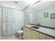 Bathroom with a shower/tub combo, light cabinets, and a coastal-themed shower curtain at 268 Lewis Cir # 132, Punta Gorda, FL 33950