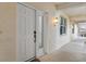 Condo building entry with white door and hallway at 268 Lewis Cir # 132, Punta Gorda, FL 33950