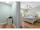 Bedroom with hardwood floors, white dresser, and access to a small office at 268 Lewis Cir # 132, Punta Gorda, FL 33950