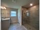 Bathroom featuring a glass shower, granite countertops, and tile floors at 27462 Pasto Dr, Punta Gorda, FL 33983