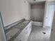 New bathroom featuring modern cabinets, granite countertops, and a bathtub at 27462 Pasto Dr, Punta Gorda, FL 33983