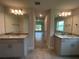 Bathroom featuring dual sinks with granite countertops and modern lighting at 27462 Pasto Dr, Punta Gorda, FL 33983