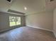 Cozy bedroom featuring tile floors and a large window offering peaceful views at 27462 Pasto Dr, Punta Gorda, FL 33983