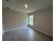 Bedroom featuring tile floors and a window overlooking the backyard at 27462 Pasto Dr, Punta Gorda, FL 33983