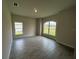 Bright bedroom with large windows and tile flooring at 27462 Pasto Dr, Punta Gorda, FL 33983