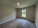 Bedroom featuring tile floors and a window overlooking the backyard at 27462 Pasto Dr, Punta Gorda, FL 33983