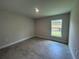 Bedroom featuring tile floors and a window overlooking the backyard at 27462 Pasto Dr, Punta Gorda, FL 33983