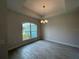 Dining room with decorative chandelier and large window at 27462 Pasto Dr, Punta Gorda, FL 33983