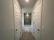 Hallway with tile flooring leading to a modern bathroom with glass shower at 27462 Pasto Dr, Punta Gorda, FL 33983