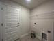 Laundry room with a door, shelving, and hookups for a washer and dryer at 27462 Pasto Dr, Punta Gorda, FL 33983