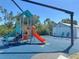 Community playground featuring slides, swings, and play structures for children at 27462 Pasto Dr, Punta Gorda, FL 33983
