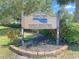 Deep Creek Golf Club public welcome sign with lush landscaping at 27462 Pasto Dr, Punta Gorda, FL 33983