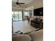 Open living space with pool view and large TV at 5101 Pine Shadow Ln, North Port, FL 34287