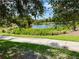 Landscaped walking path alongside a peaceful community lake at 5101 Pine Shadow Ln, North Port, FL 34287