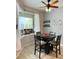 Bright breakfast nook features a table with four chairs and a view to the backyard at 5101 Pine Shadow Ln, North Port, FL 34287
