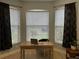 Home office boasts built-in shelving and plenty of natural light at 5101 Pine Shadow Ln, North Port, FL 34287