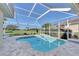 Relaxing screened pool with view of lush landscaping at 5101 Pine Shadow Ln, North Port, FL 34287