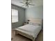 Light and airy bedroom with a queen-size bed and wood floors at 5101 Pine Shadow Ln, North Port, FL 34287