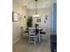 Casual dining area with four chairs and a chandelier at 5101 Pine Shadow Ln, North Port, FL 34287