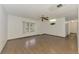 Spacious living room featuring tile floors and a ceiling fan at 5453 Simrak St, North Port, FL 34287