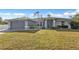 Single story home with attached garage and well-manicured lawn at 13497 Chancellor Blvd, Port Charlotte, FL 33953