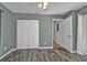Spacious bedroom with wood-look floors and double door closet at 13497 Chancellor Blvd, Port Charlotte, FL 33953