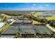 Aerial view of tennis courts and a resort-style pool at 14151 Heritage Landing Blvd # 1021, Punta Gorda, FL 33955