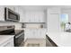 Modern kitchen with stainless steel appliances and white cabinetry at 14151 Heritage Landing Blvd # 1021, Punta Gorda, FL 33955