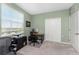 Home office with a work station, comfortable chair and large window at 14151 Heritage Landing Blvd # 1021, Punta Gorda, FL 33955