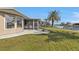 Home exterior showing a screened in porch, big windows, and a lawn with white rocks at 201 W Tarpon Nw Blvd, Port Charlotte, FL 33952