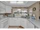 Bright kitchen featuring white cabinetry, neutral countertops, and scenic waterfront views at 201 W Tarpon Nw Blvd, Port Charlotte, FL 33952
