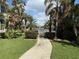 Paved walkway leads to waterfront with tropical landscaping at 2620 Tarpon Cove Dr # 311, Punta Gorda, FL 33950