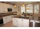 Bright kitchen featuring granite countertops, updated cabinetry, and stainless steel appliances at 2620 Tarpon Cove Dr # 311, Punta Gorda, FL 33950