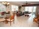 Bright living room with leather furniture, glass dining table, and water views at 2620 Tarpon Cove Dr # 311, Punta Gorda, FL 33950