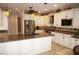 Modern kitchen with white cabinets, stainless steel appliances, and granite countertops at 2620 Tarpon Cove Dr # 311, Punta Gorda, FL 33950